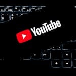 YouTube logo displayed on a backlit keyboard, representing digital media and online content creation.